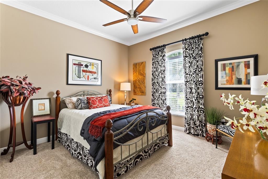 4846 Calasans Avenue St. Cloud, FL 34771 - Photo 23 of 61 a bedroom with a bed a wall painting and a window