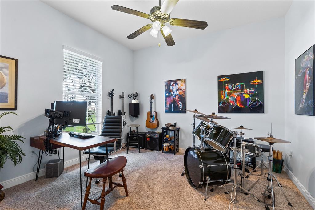 4846 Calasans Avenue St. Cloud, FL 34771 - Photo 26 of 61 a living room with furniture a flat screen tv and a window