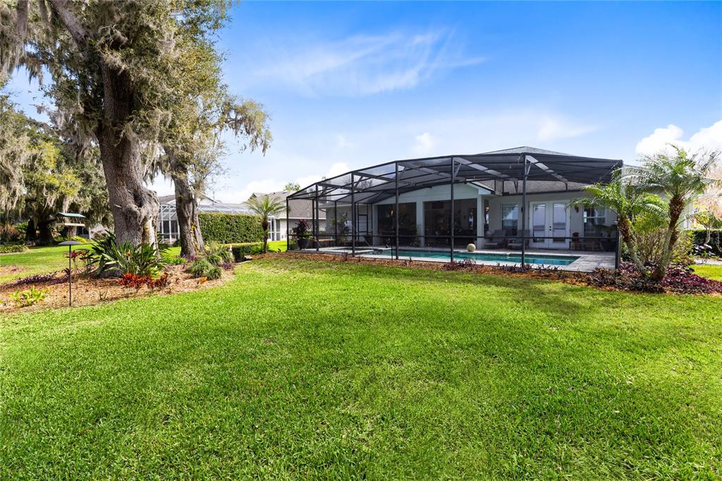 4846 Calasans Avenue St. Cloud, FL 34771 - Photo 39 of 61 a view of a big yard with table and chairs under an umbrella