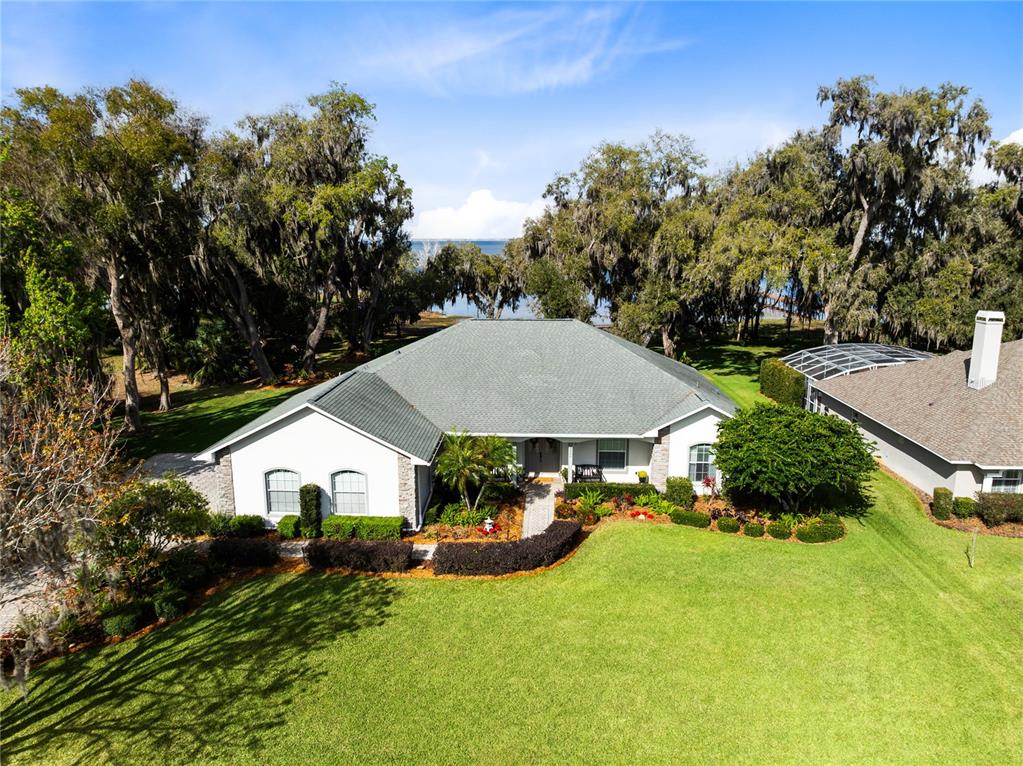4846 Calasans Avenue St. Cloud, FL 34771 - Photo 47 of 61 a view of house with garden and tall trees