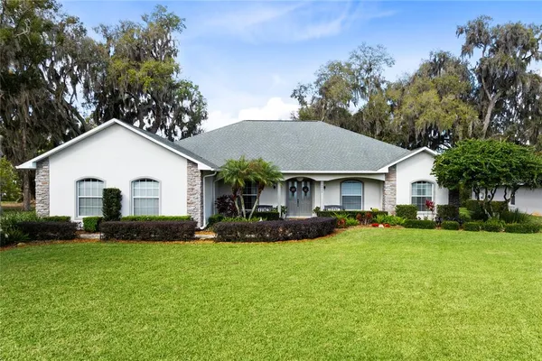 a front view of a house with a yard and a garage