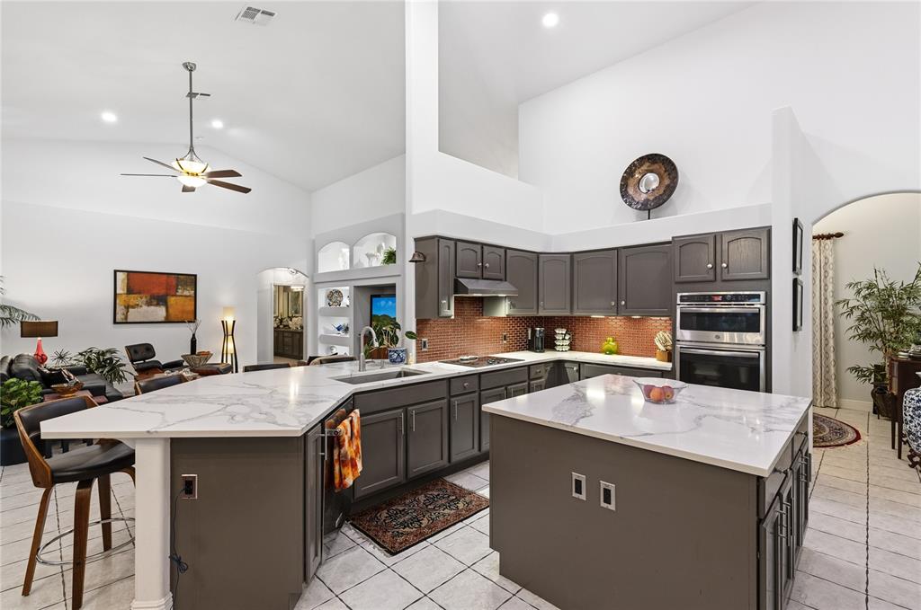 4846 Calasans Avenue St. Cloud, FL 34771 - Photo 8 of 61 a kitchen with a sink a stove and chairs