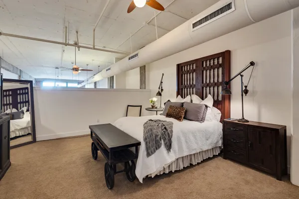 a bedroom with a bed a chandelier and closet