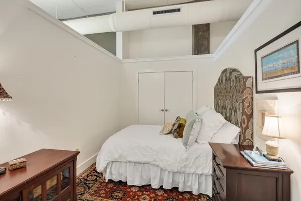 a bedroom with a bed and a dresser