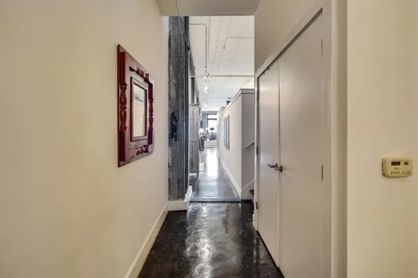 a view of hallway with wooden floor