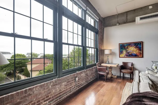 a living room with furniture and a large window with outer view