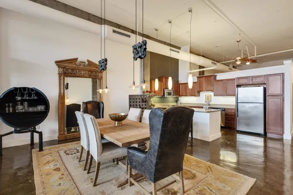 a dining room with furniture and a chandelier