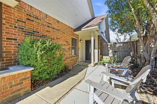 a view of a patio with table and chairs and potted plants