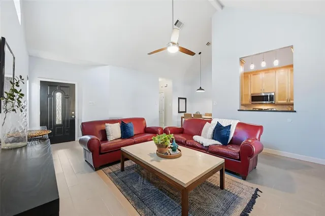 a living room with furniture a rug and a chandelier