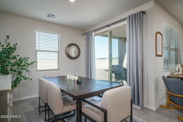 a view of a kitchen area with furniture and stainless steel appliances