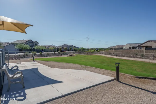 a view of a house with swimming pool and chairs