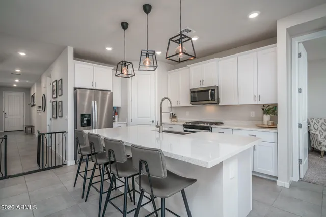 a living room with furniture and a view of kitchen