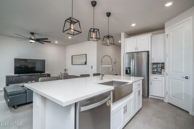 a view of kitchen with sink microwave and cabinets