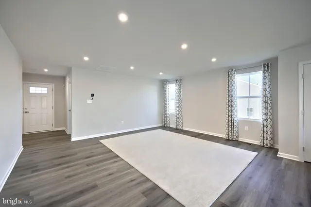 a view of an empty room and wooden floor