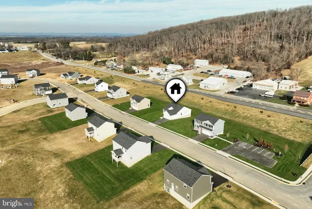 an aerial view of residential houses with outdoor space