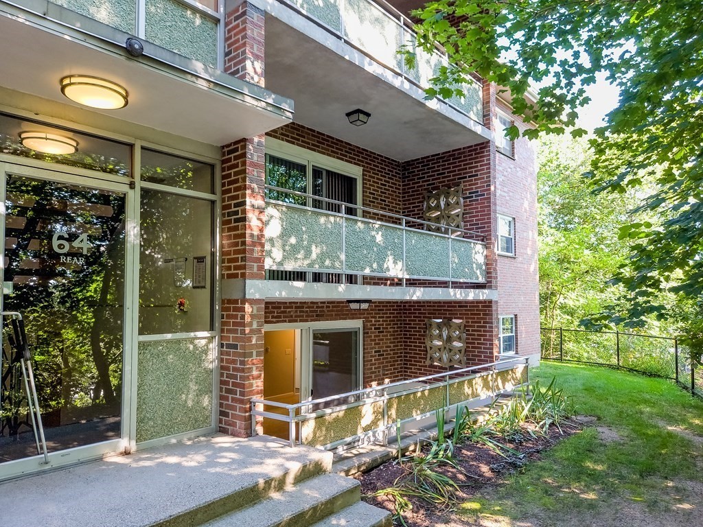 64 Jacqueline Road, Unit 3 Waltham, MA 02452 - Photo 1 of 27 a front view of a house with a yard