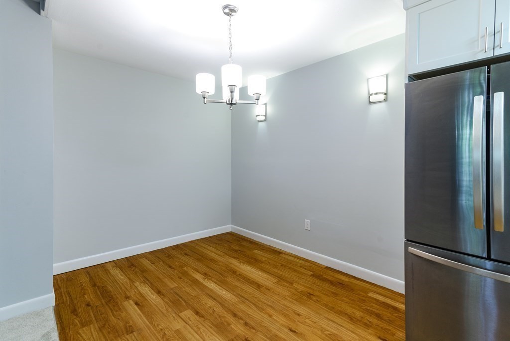 64 Jacqueline Road, Unit 3 Waltham, MA 02452 - Photo 14 of 27 a view of empty room with wooden floor