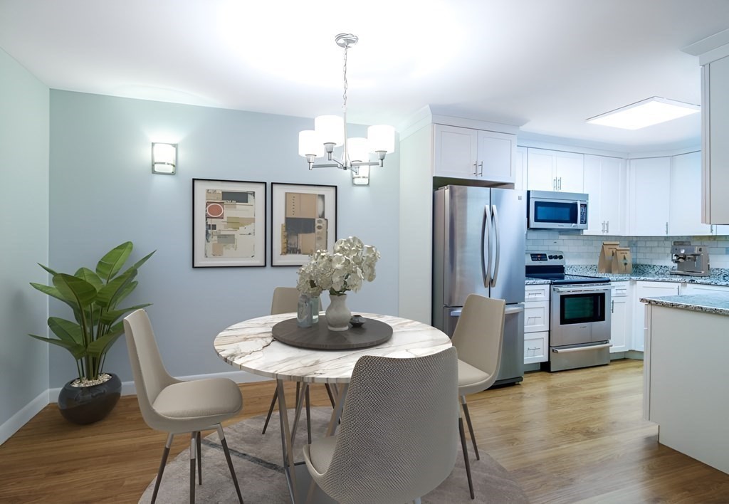 64 Jacqueline Road, Unit 3 Waltham, MA 02452 - Photo 3 of 27 a kitchen with stainless steel appliances granite countertop a dining table and chairs