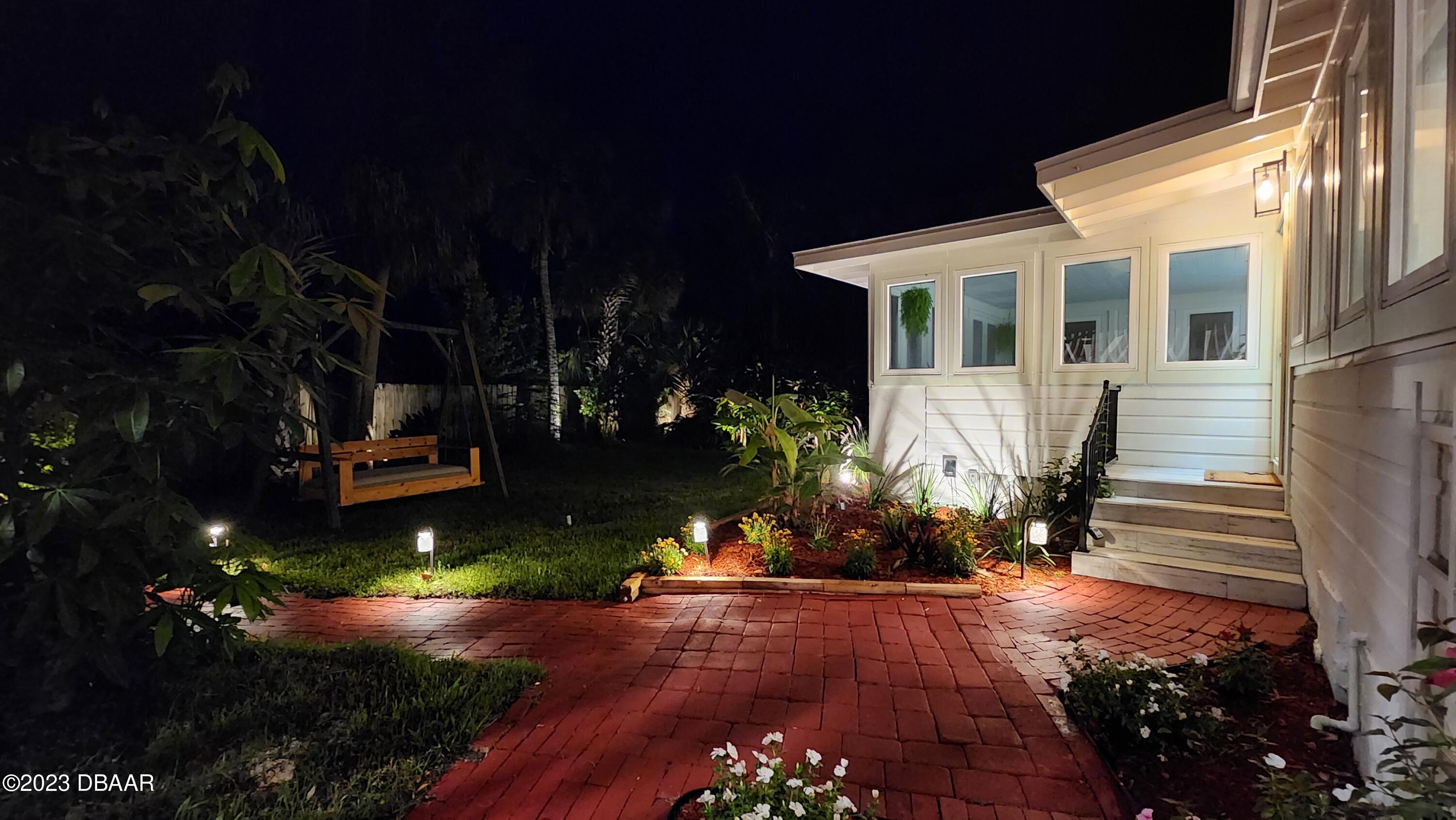 912 North Halifax Drive Ormond Beach, FL 32176 - Photo 11 of 65 a front view of a house with a yard