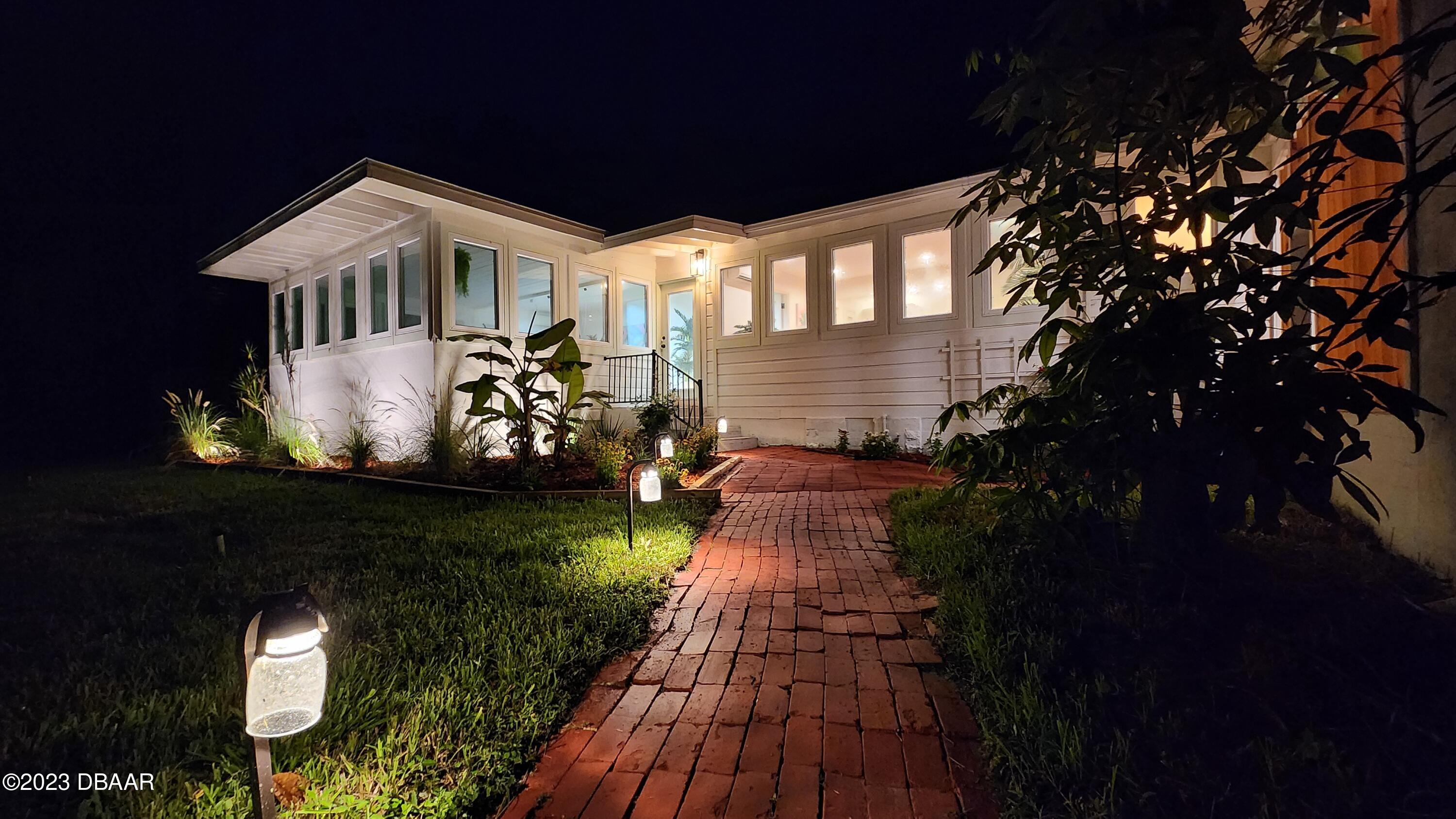 912 North Halifax Drive Ormond Beach, FL 32176 - Photo 13 of 65 a front view of a house with a yard