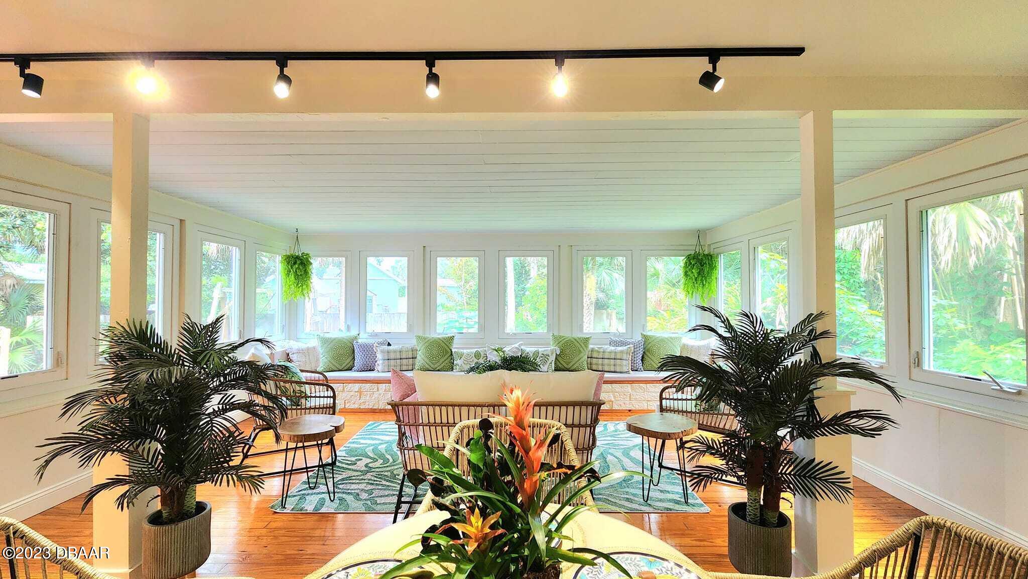 912 North Halifax Drive Ormond Beach, FL 32176 - Photo 22 of 65 a living room with furniture and floor to ceiling windows