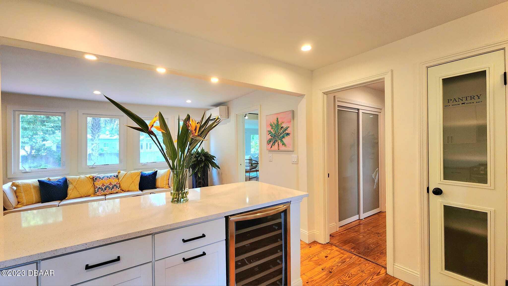 912 North Halifax Drive Ormond Beach, FL 32176 - Photo 36 of 65 a kitchen with stainless steel appliances a counter top space cabinets and a potted plant