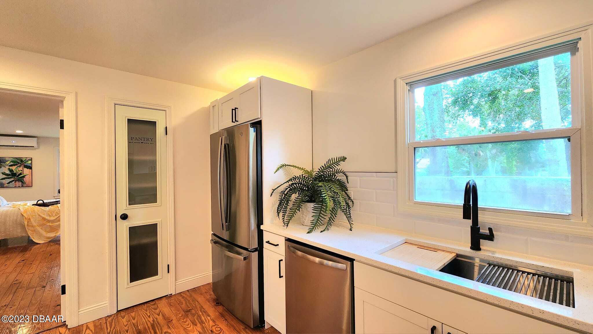 912 North Halifax Drive Ormond Beach, FL 32176 - Photo 39 of 65 a view of a kitchen with a sink and a window