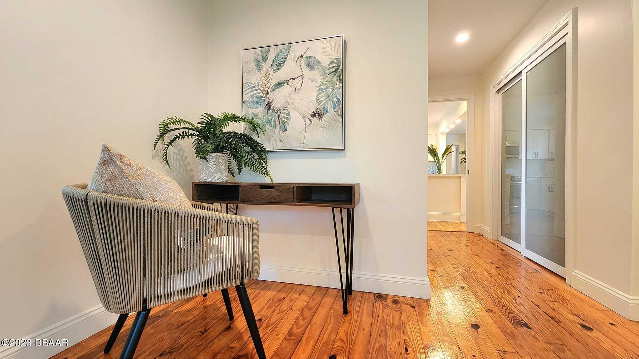 912 North Halifax Drive Ormond Beach, FL 32176 - Photo 45 of 65 a view of a hallway with paintings on the wall