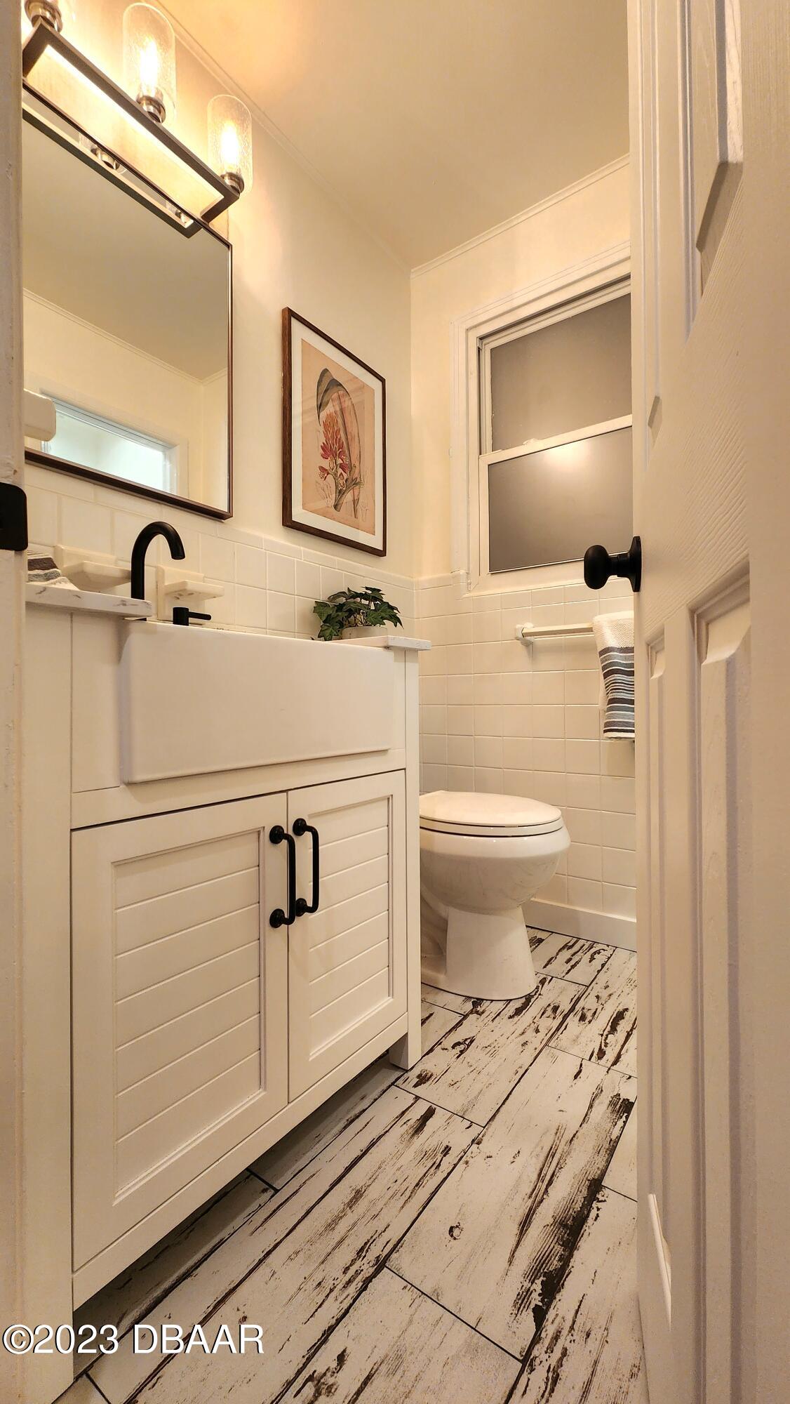 912 North Halifax Drive Ormond Beach, FL 32176 - Photo 51 of 65 a bathroom with a toilet sink and mirror