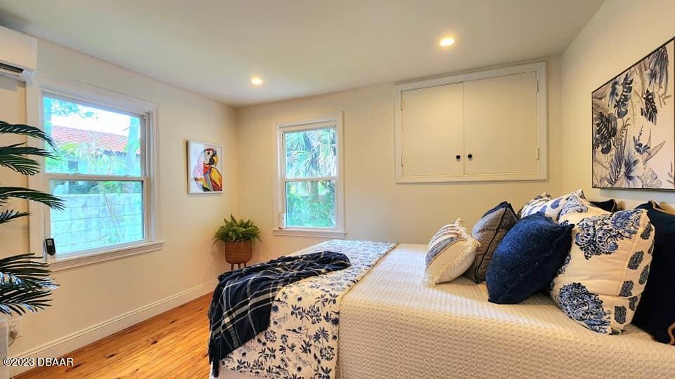 912 North Halifax Drive Ormond Beach, FL 32176 - Photo 54 of 65 a bed sitting in a bedroom next to a window