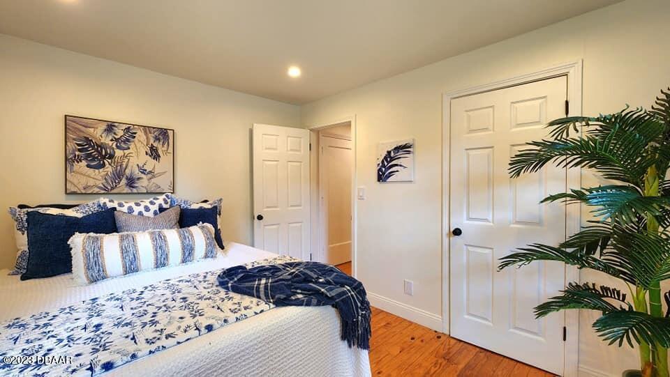 912 North Halifax Drive Ormond Beach, FL 32176 - Photo 55 of 65 a bedroom with a large bed and a potted plant