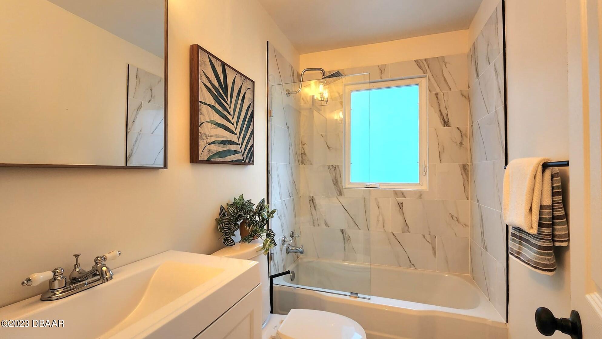 912 North Halifax Drive Ormond Beach, FL 32176 - Photo 57 of 65 a bathroom with a sink a bathtub and a shower