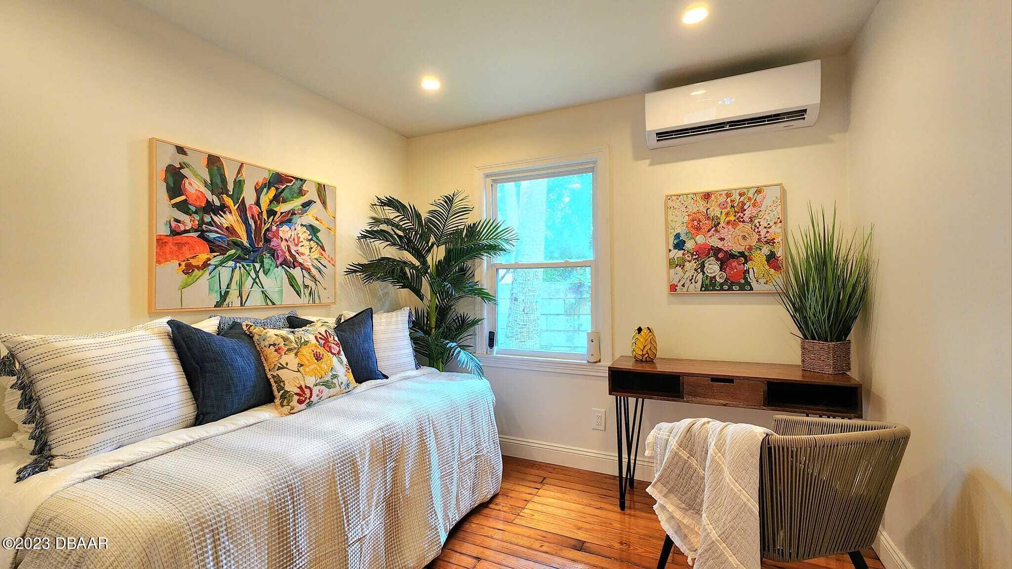 912 North Halifax Drive Ormond Beach, FL 32176 - Photo 59 of 65 a bedroom with a bed and a painting on the wall