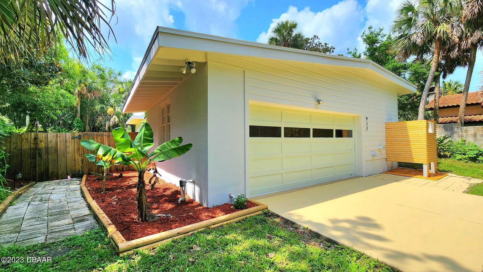 912 North Halifax Drive Ormond Beach, FL 32176 - Photo 6 of 65 a front view of a house with a yard