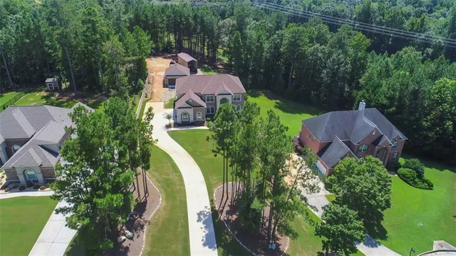 an aerial view of house with yard swimming pool and outdoor seating