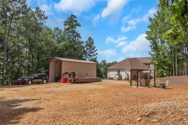 a bathroom with a granite countertop sink a mirror and a bathtub
