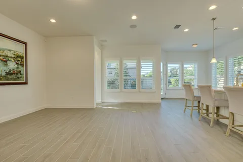 a view of a room with furniture and wooden floor