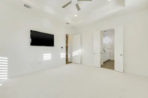 en empty room with windows and television