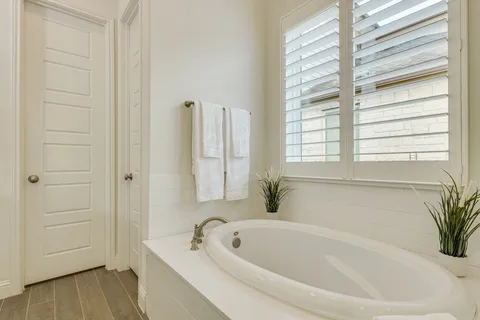 a white bath tub sitting next to a window
