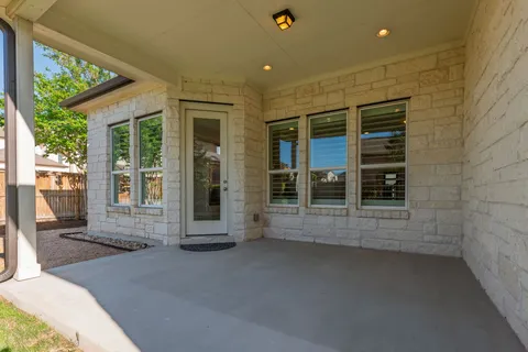 a view of a brick house with a large window