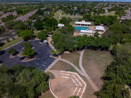 an aerial view of a house with a yard and lake view