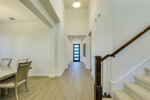 a view of a livingroom with wooden floor and furniture
