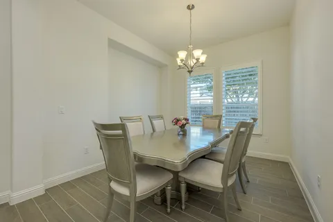 a view of a dining room with furniture window and chandelier
