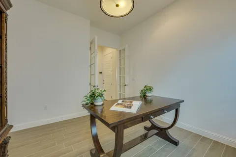 a view of a room with a table and chairs