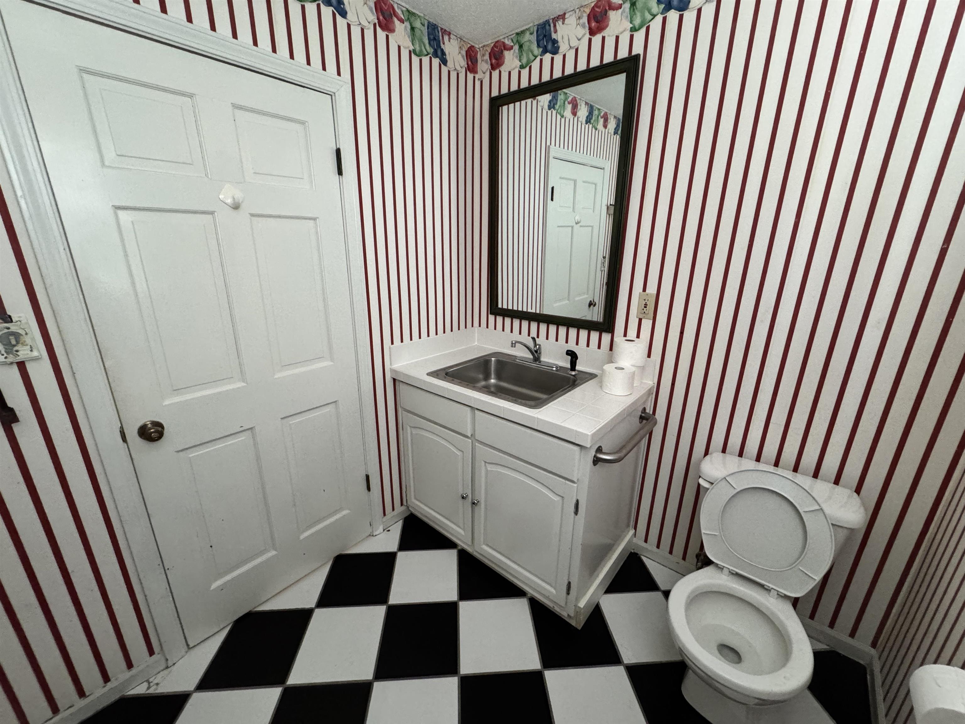 1979 Kirby Parkway Memphis, TN 38119 - Photo 12 of 28 a bathroom with a granite countertop toilet and a sink