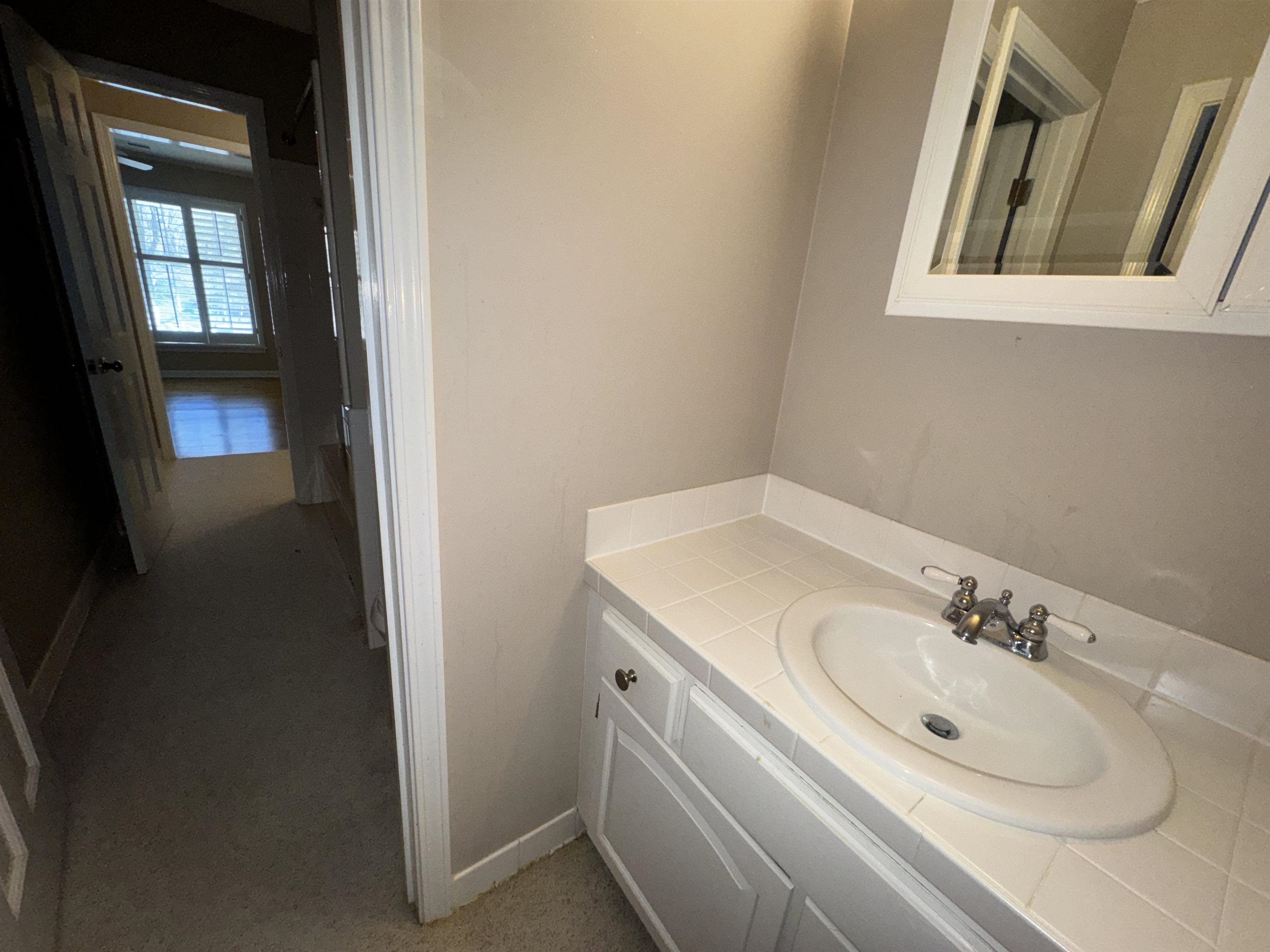 1979 Kirby Parkway Memphis, TN 38119 - Photo 21 of 28 a bathroom with a sink and a mirror