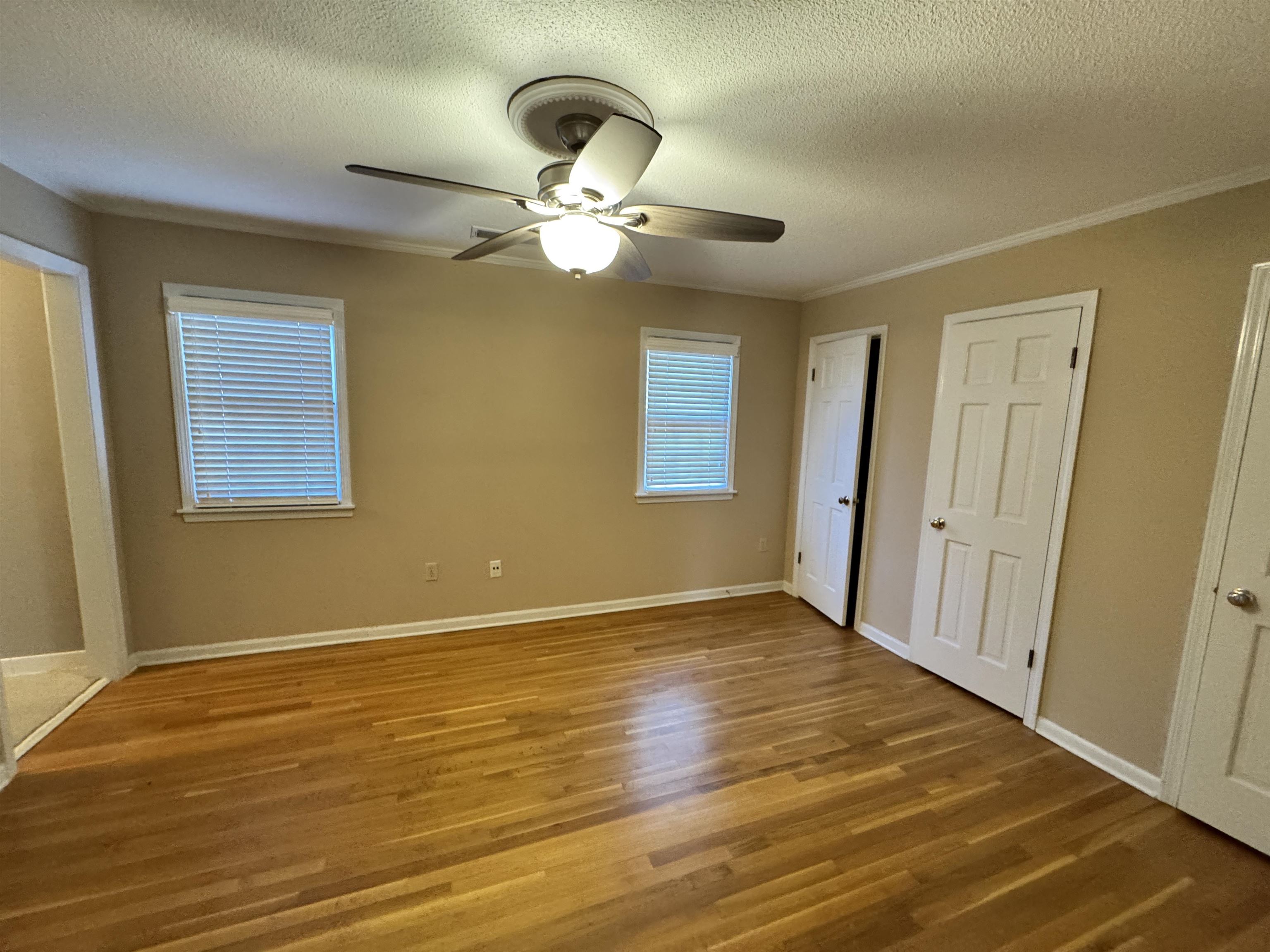 1979 Kirby Parkway Memphis, TN 38119 - Photo 22 of 28 a view of an empty room with wooden floor and a window