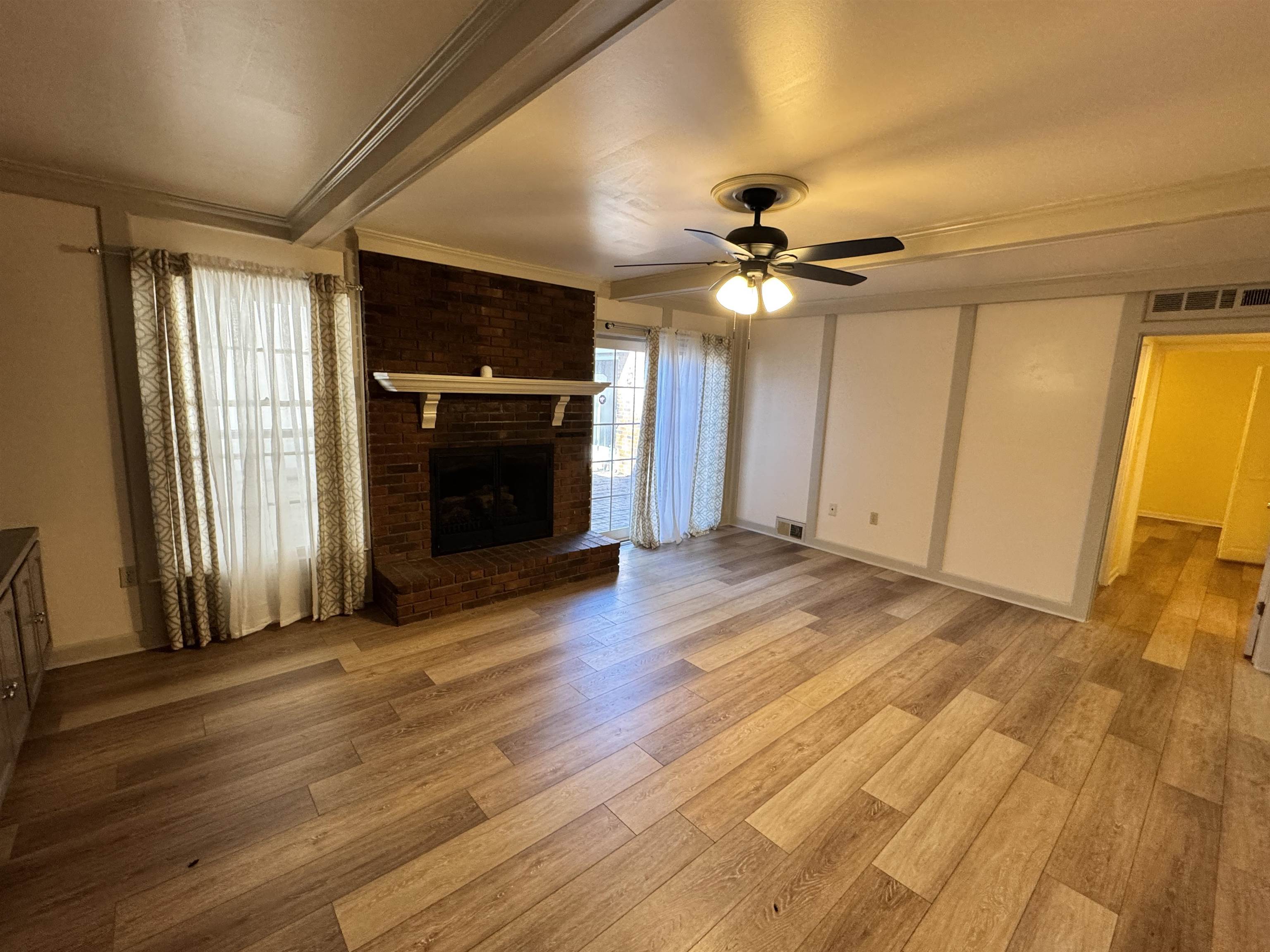 1979 Kirby Parkway Memphis, TN 38119 - Photo 8 of 28 a view of an empty room with a fireplace and a window