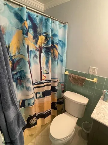 a white toilet sitting next to a bathroom sink