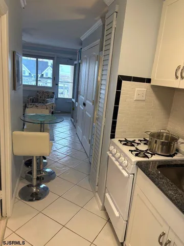 a kitchen with a sink and a stove top oven